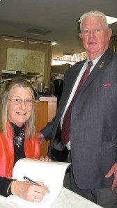 Helen signing a book for Brian Grogan OAM 